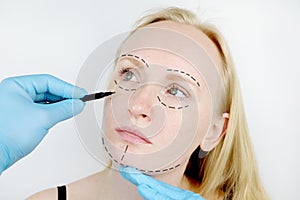 Facial plastic surgery or facelift, facelift, face correction. A plastic surgeon examines a patient before plastic surgery