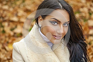 Facial portrait of a beautiful arab woman warmly clothed outdoor