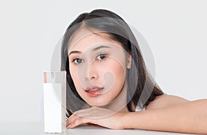 Facial portrait shot of millennial young Asian short black hair sexy female model look at camera with organic natural serum