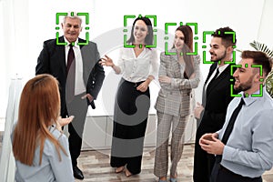 Facial recognition system identifying people at business meeting
