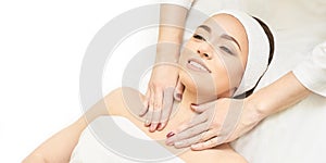 Facial salon massage. Woman professional therapy. Hands at neck. Healthy cosmetic procedure. Luxury spa treatment