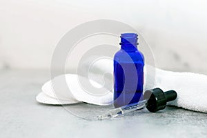 Facial serum in blue bottle