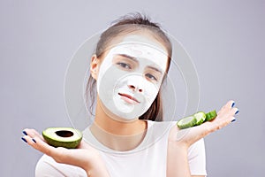 Facial skin care. Young girl makes a moisturizing cleansing face mask