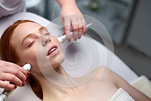 Facial skin rejuvenation by microcurrent therapy in cosmetology salon