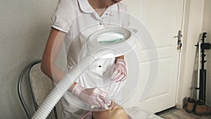 Facial Skin Treatment. Woman Receiving Cosmetic Mask In Beauty Salon. Beautician Applying Alginate Mask On Female Face