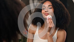 Facial skincare beauty routine African American woman beautiful young girl with cotton pad wipe wash cleaning face