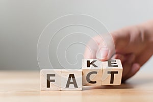 Fact or Fake concept, Hand flip wood cube change the word, April