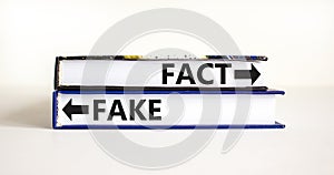 Fact or fake symbol. Concept word Fake and Fact on beautiful books. Beautiful white table white background. Business and fact or