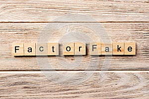 Fact or fake word written on wood block. fact or fake text on table, concept