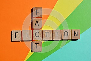 Fact and Fiction, words in wood alphabet letters on colorful background