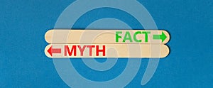 Fact or myth symbol. Concept word Myth and Fact on beautiful wooden stick. Beautiful blue table blue background. Business and fact