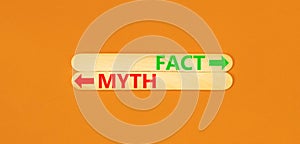 Fact or myth symbol. Concept word Myth and Fact on beautiful wooden stick. Beautiful orange table orange background. Business and