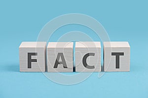 Fact is standing on wooden cubes, truth concept, social media and news