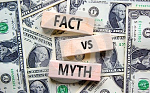 Fact vs myth symbol. Concept words Fact vs myth on wooden blocks on a beautiful background from dollar bills. Business, finacial