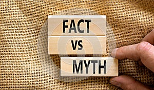 Fact vs myth symbol. Concept words Fact vs myth on wooden blocks on a beautiful canvas table canvas background. Businessman hand.