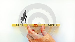 Fact vs myth symbol. Concept words Fact vs myth on wooden blocks on a beautiful white table white background. Businessman hand.