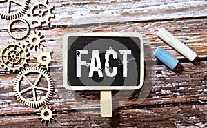 Fact - word through magnifying glass on yellow background