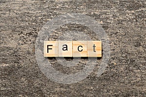 fact word written on wood block. fact text on table, concept