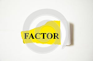 FACTOR the text is written on a white background and a yellow piece of paper