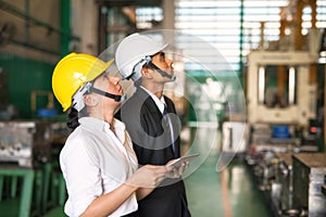 Factory auditor and inspector manager look up to check factory hardware safety