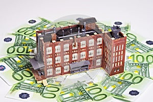Factory building and banknotes