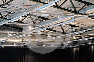 Factory building or warehouse building. Vast empty space with ventilation pipes and lights