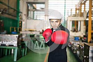 Factory businessman with boxing gloves