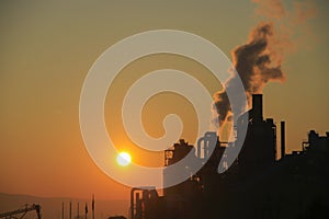 Factory chimney smoking, heavy black smoke on the sky. ecology problems