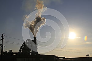 Factory chimney smoking, heavy black smoke on the sky. ecology problems
