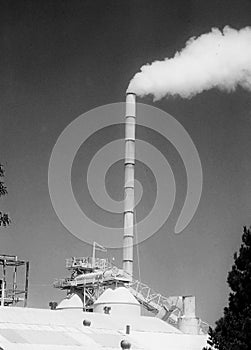 Factory chimney spews smoke photo