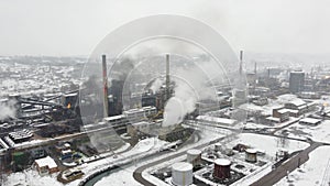 Factory chimneys blowing pollution in environment. Aerial drone view of industry complex. Industrial air pollution from smokestack
