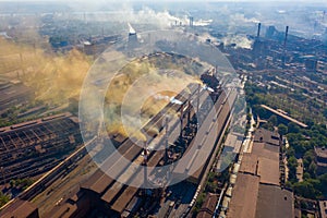 Factory chimneys emit a caustic chemical fume that disrupts the city's ecology