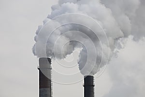 Factory chimneys smoking with dense white smoke. Industrial pollution of air, electric plant emission,  environment ecology proble
