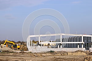Factory construction site with workers and machinery