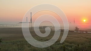 Factory at dawn in the mist timelaps