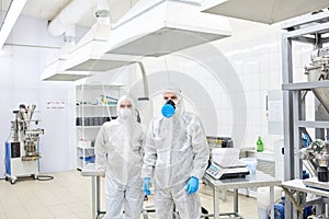 Factory employees standing in protective clothing