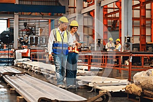 Factory engineer with assistant using inspect factory. Pano Exemplifying