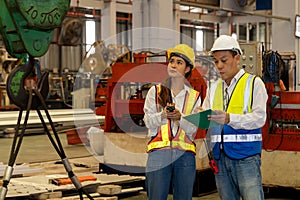 Factory engineer with assistant using laptop inspect factory. Pano Exemplifying