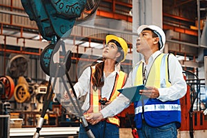 Factory engineer with assistant using laptop inspect factory. Pano Exemplifying