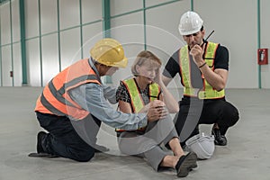 Factory engineer helping injured employee Notification of incidents to the medical team