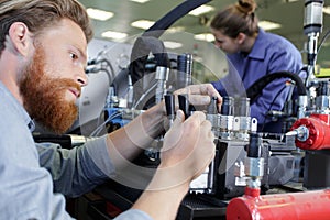 factory engineer operating hydraulic tube bender