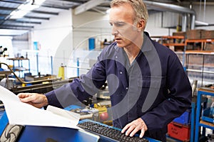 Factory Engineer Operating Hydraulic Tube Bender