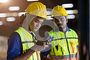 Factory engineer worker reading bad news lay off notify at smartphone serious worry expression