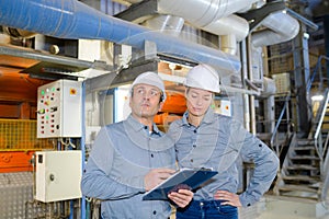 factory engineers operating hydraulic tube bender