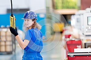Factory female worker operating workshop gantry crane photo