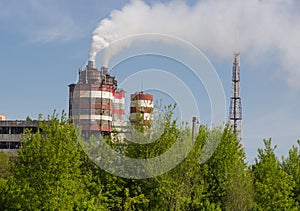 Factory with industrial smoke stacks on nature