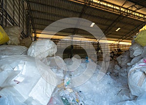 Factory industry with stack of different types of large garbage dump, plastic bags, bottles and trash bins in urban area in