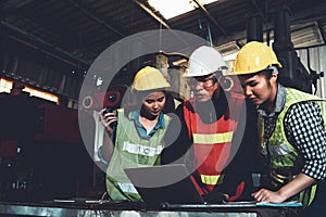 Factory job workers working and discussing manufacturing plan in the factory