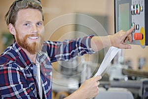 Factory maintenance worker looking at camera