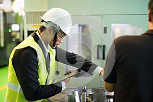 Factory manager check command worker to use lathe machine robot